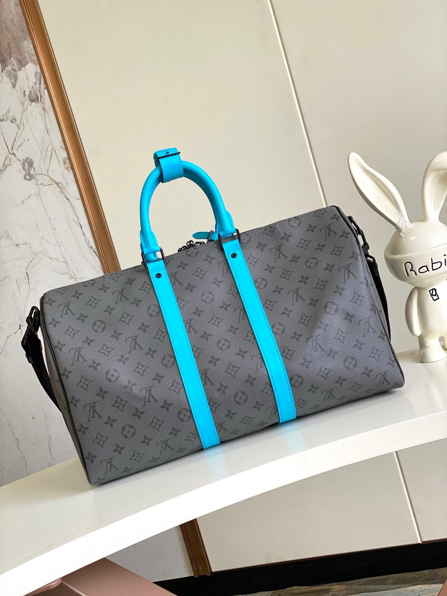 Louis Vuitton Keepall Bandoulière in Monogram Eclipse with Turquoise Accents - Authentic & Brand New Exclusive Apparel