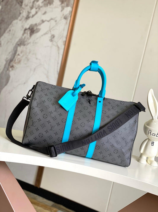 Louis Vuitton Keepall Bandoulière in Monogram Eclipse with Turquoise Accents - Authentic & Brand New Exclusive Apparel